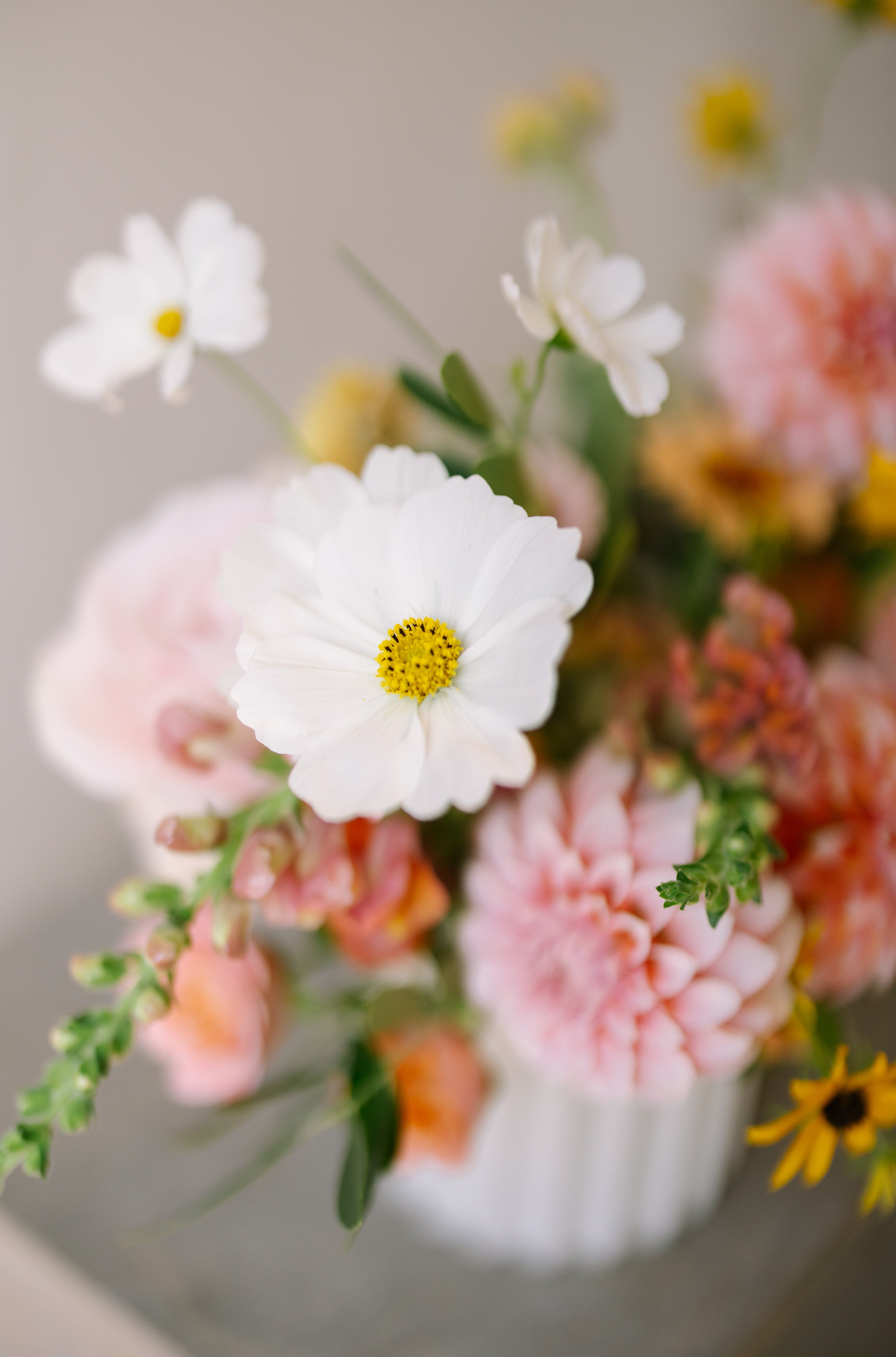 Garden flower arrangement in a textured white vase