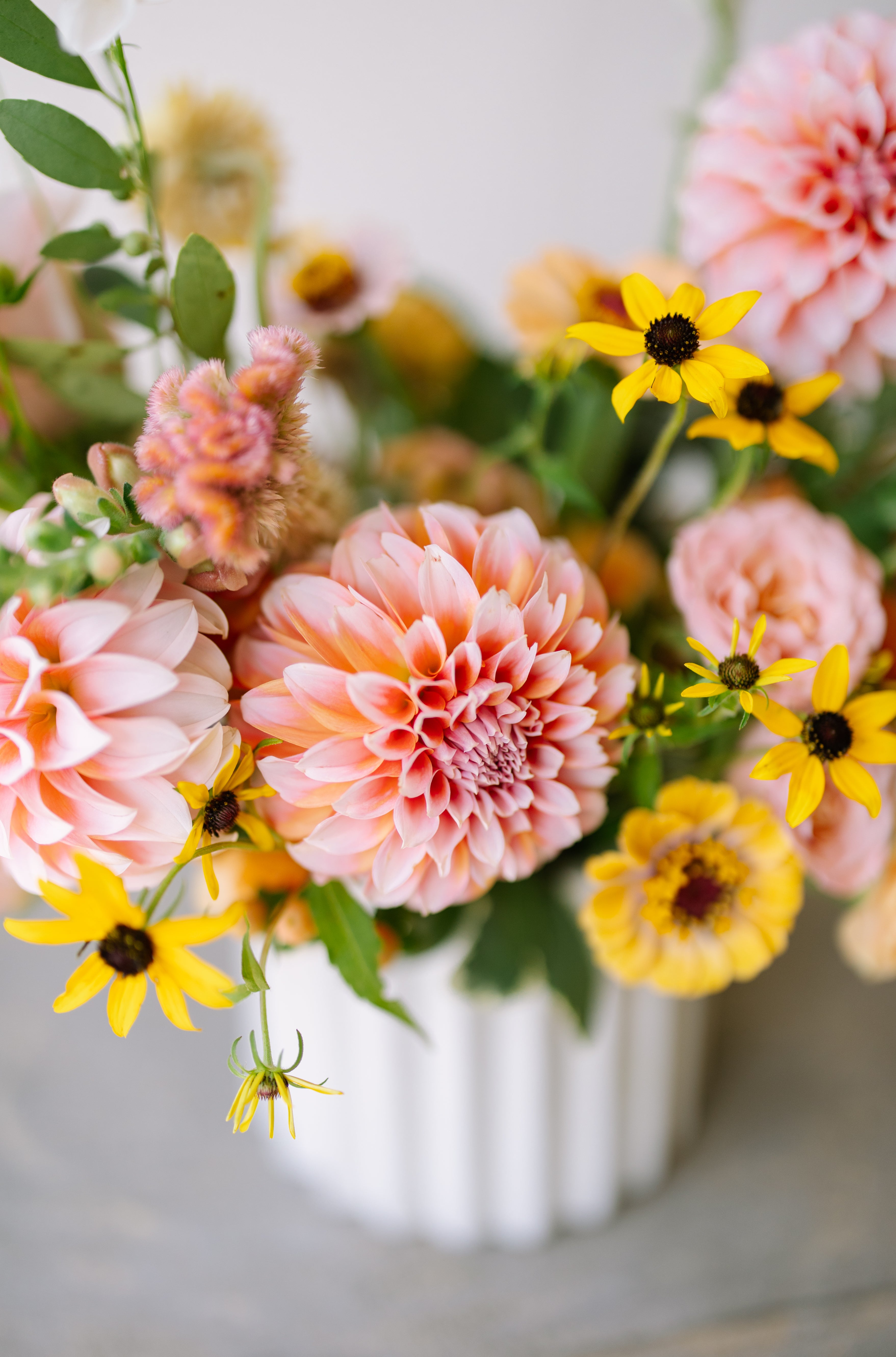 Garden flower arrangement in a textured white vase