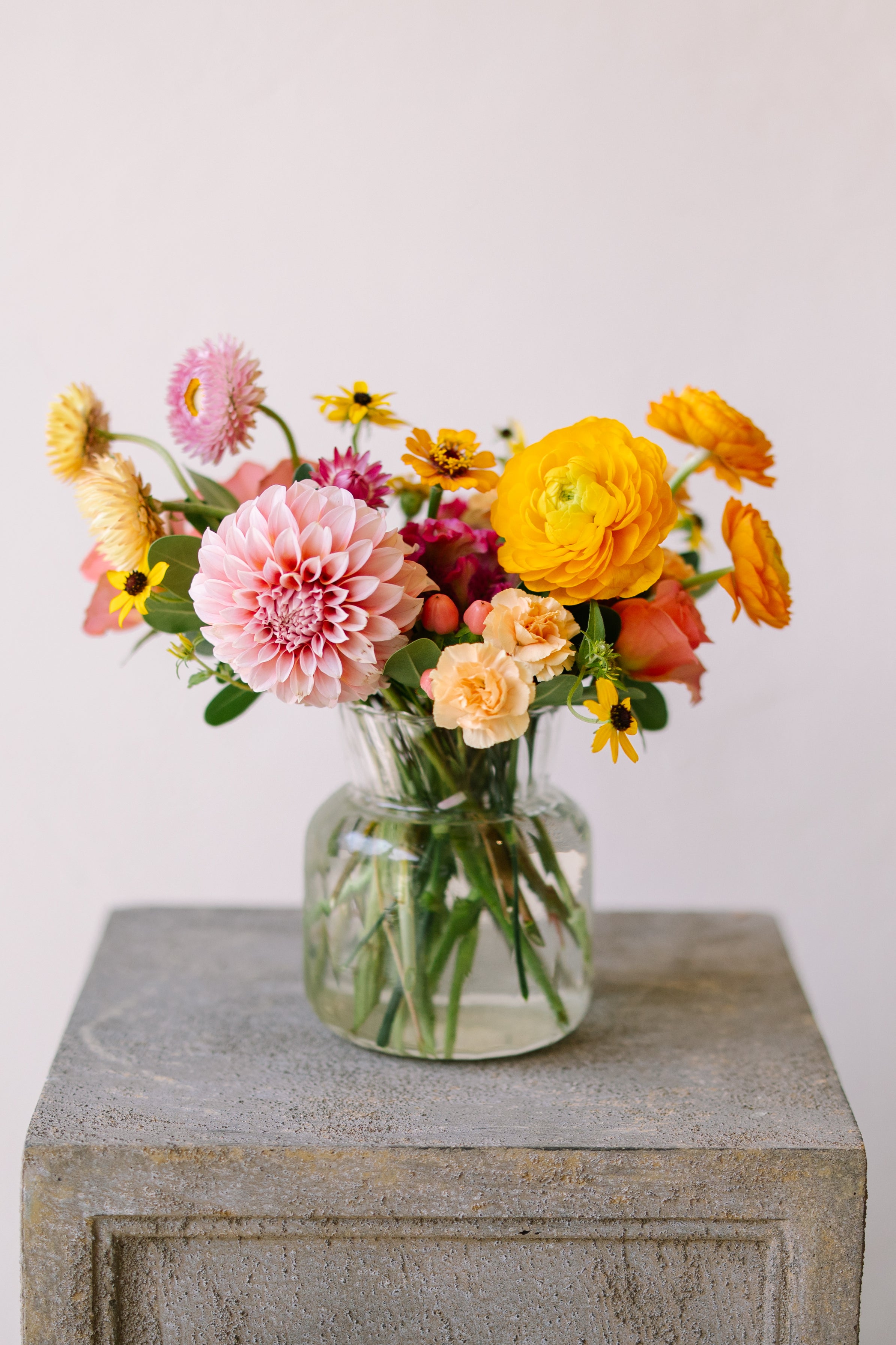 Cute and classic flower arrangement in ribbed glass vase.
