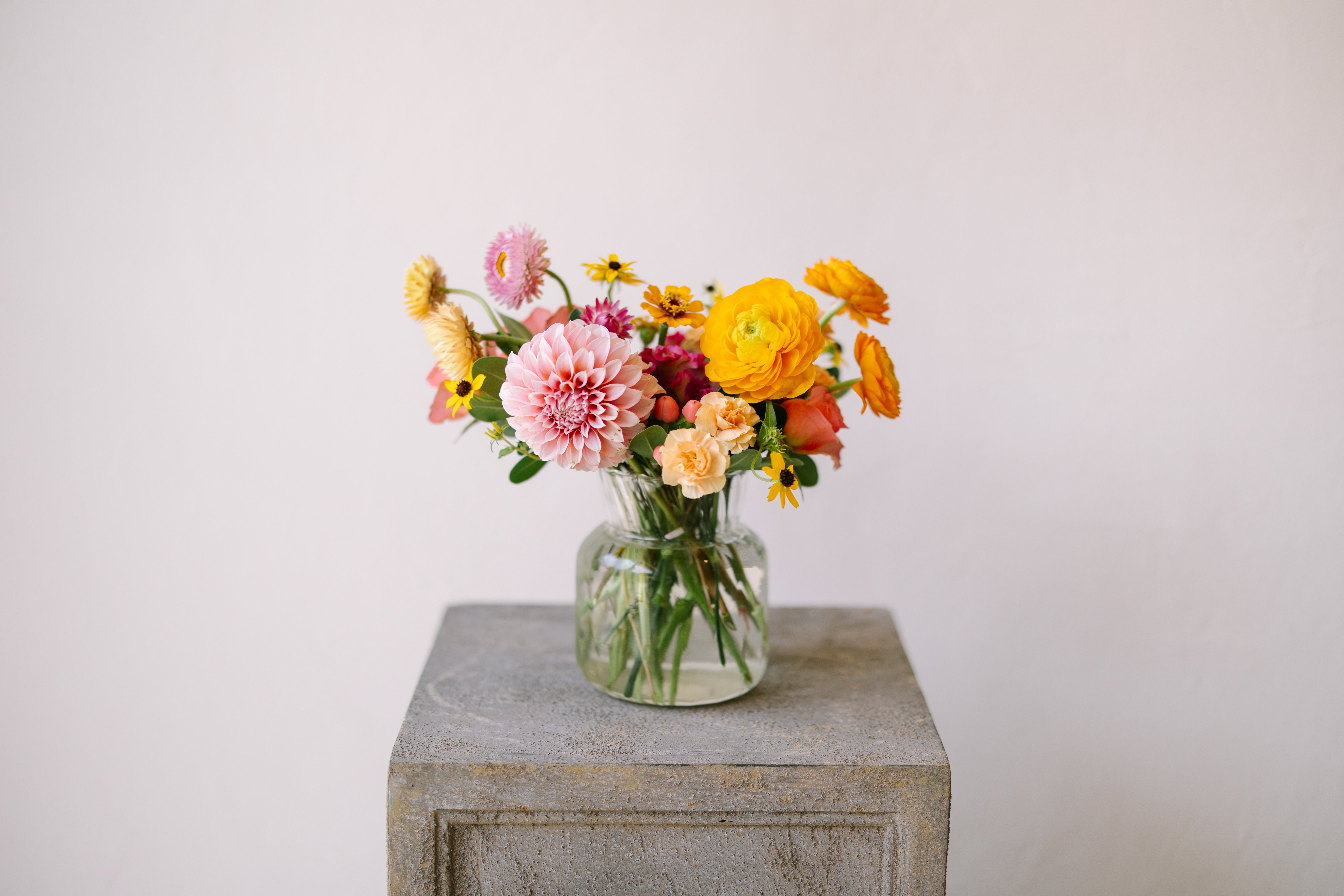 Cute and classic flower arrangement in ribbed glass vase.