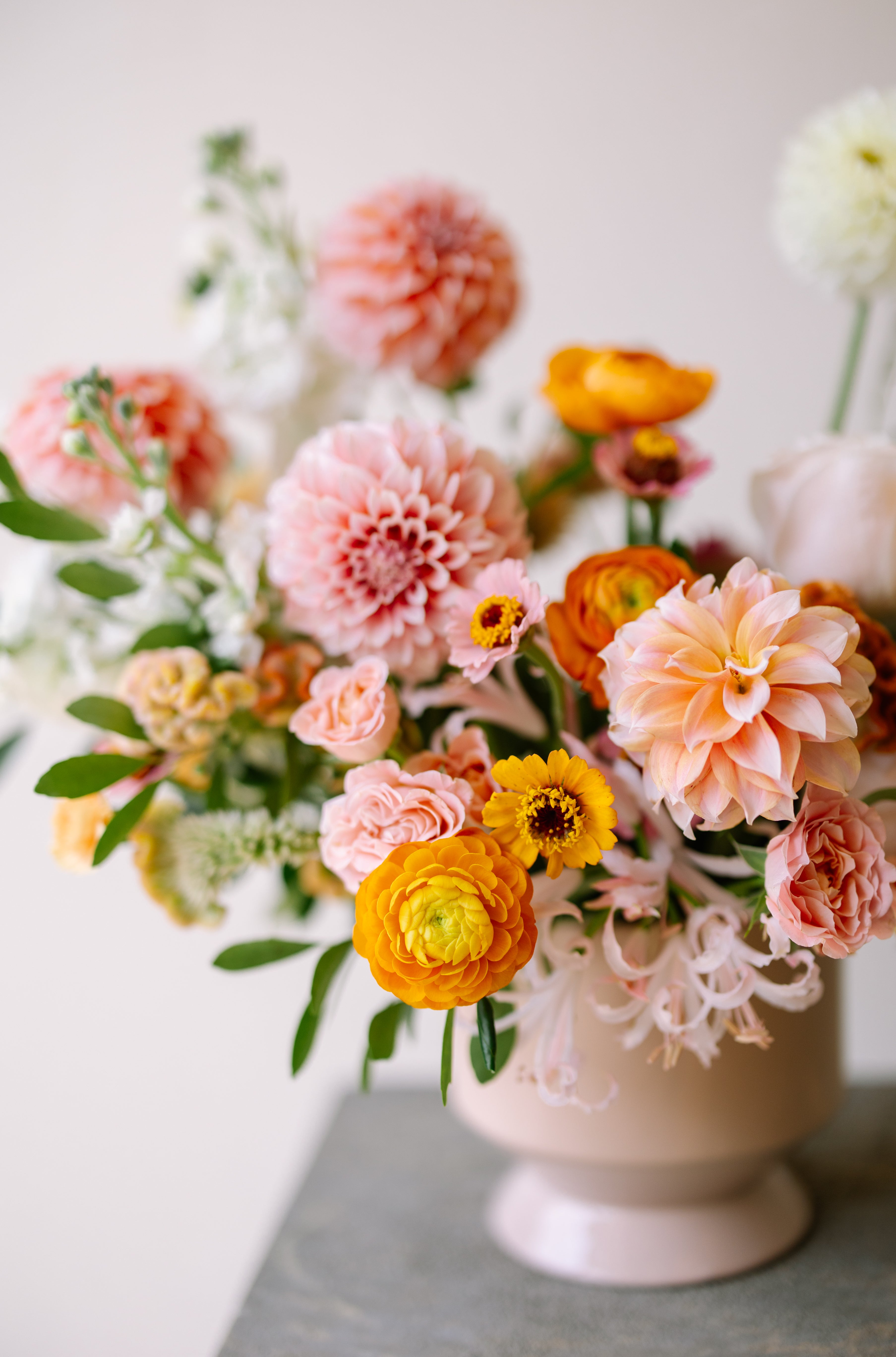 Luxury garden flower arrangement in neutral pink vase.