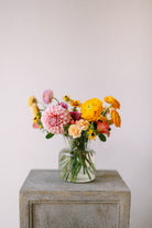 Cute and classic flower arrangement in ribbed glass vase.