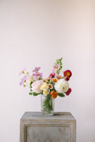 Small flower arrangement in ribbed glass vessel. 